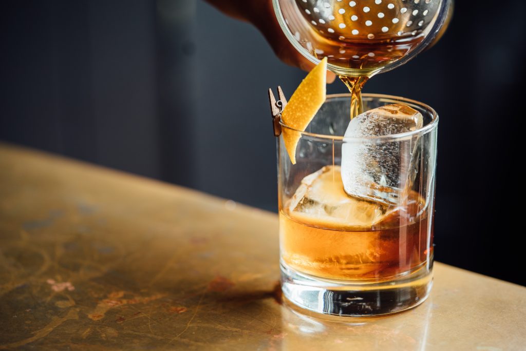 whiskey being poured into a small cup
