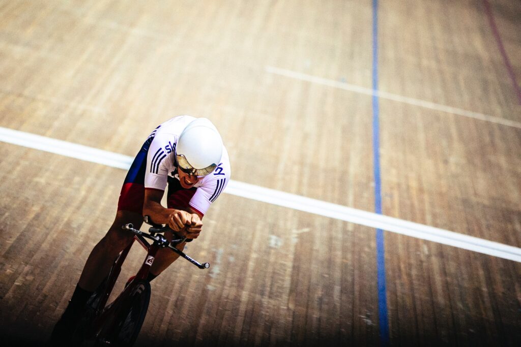 man competitively cycling